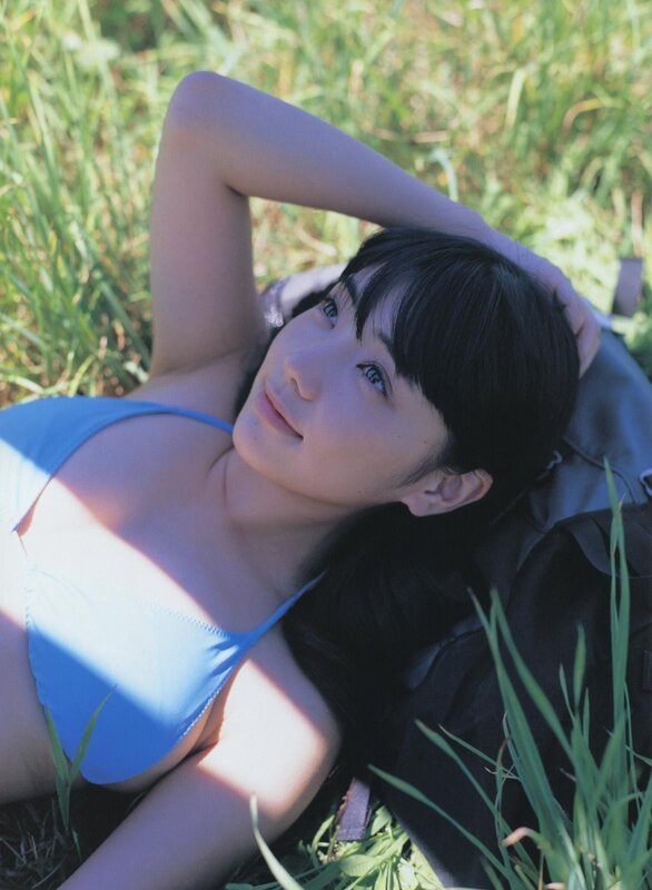 woman in blue bikini lying on grass
