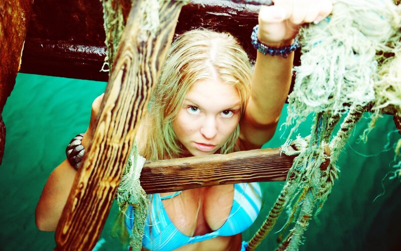 woman in blue bikini on wooden structure