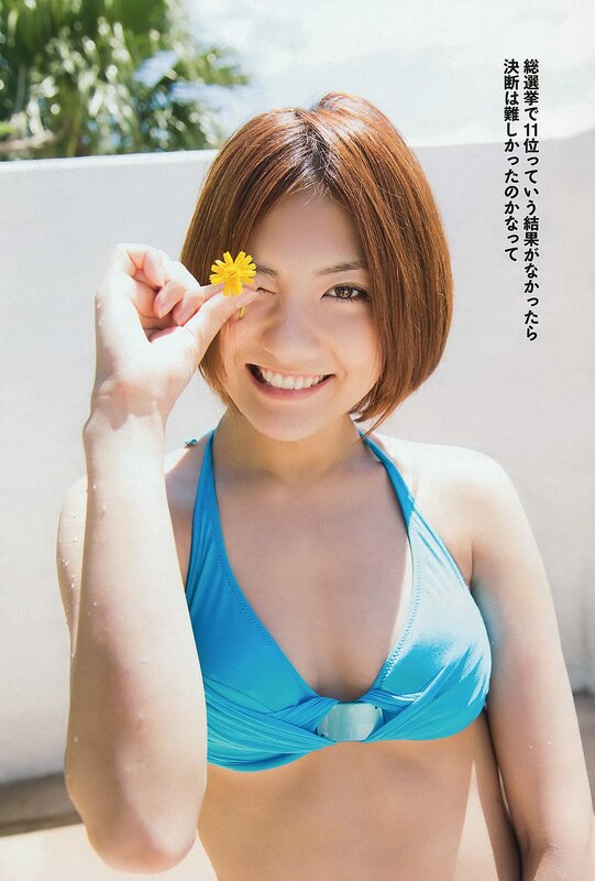 Woman in blue bikini with flower