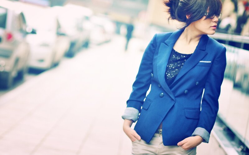 woman in blue blazer on street