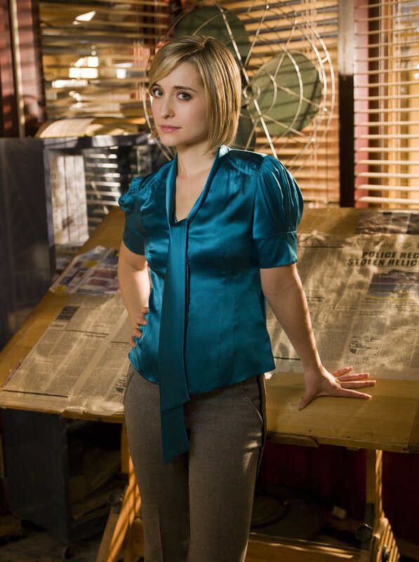 woman in blue blouse standing