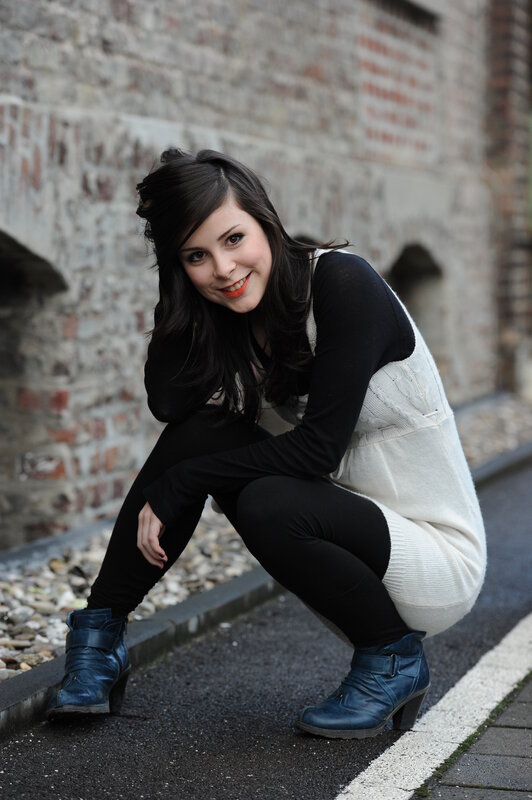 woman in blue boots crouching