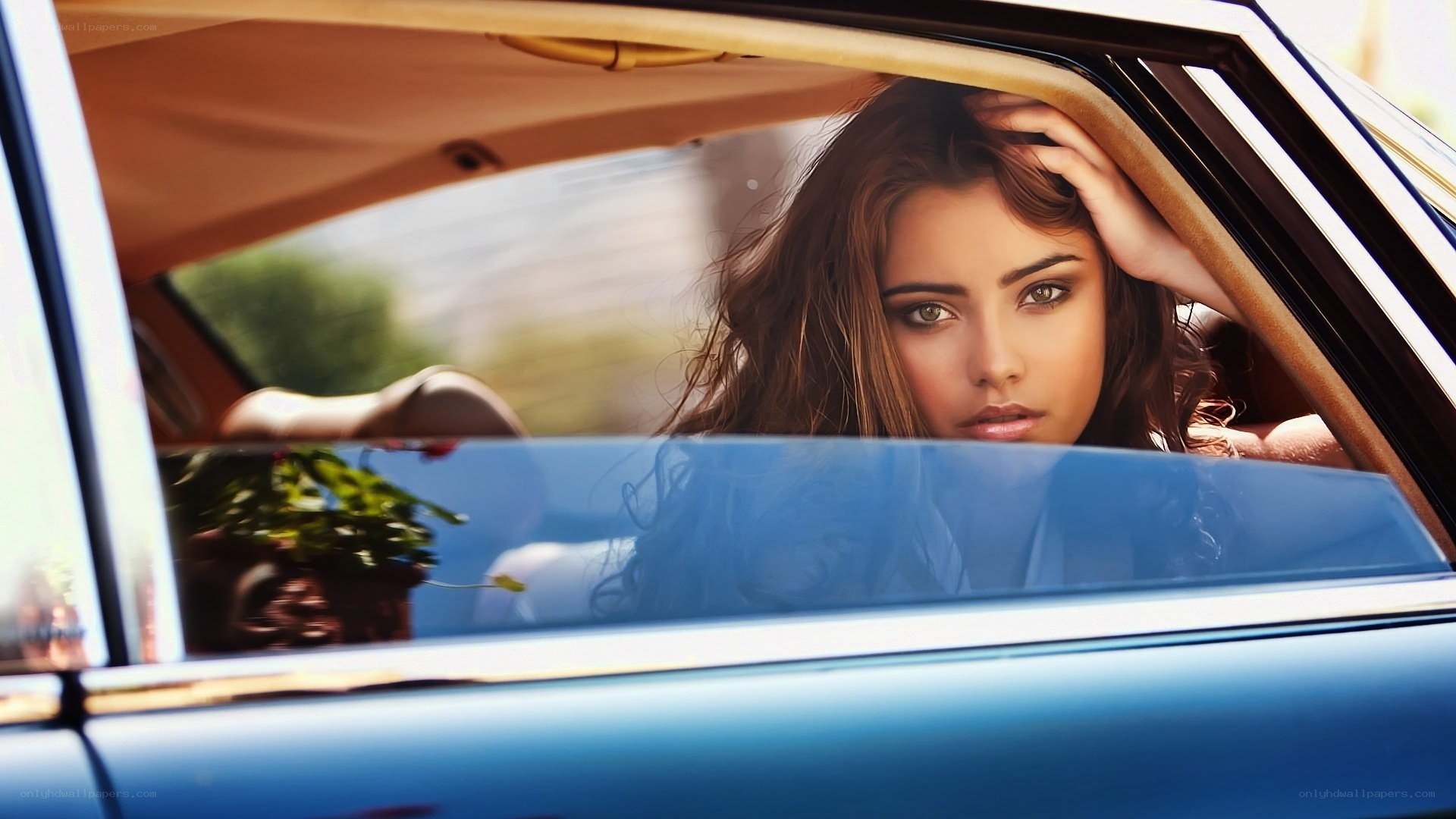 woman in blue car
