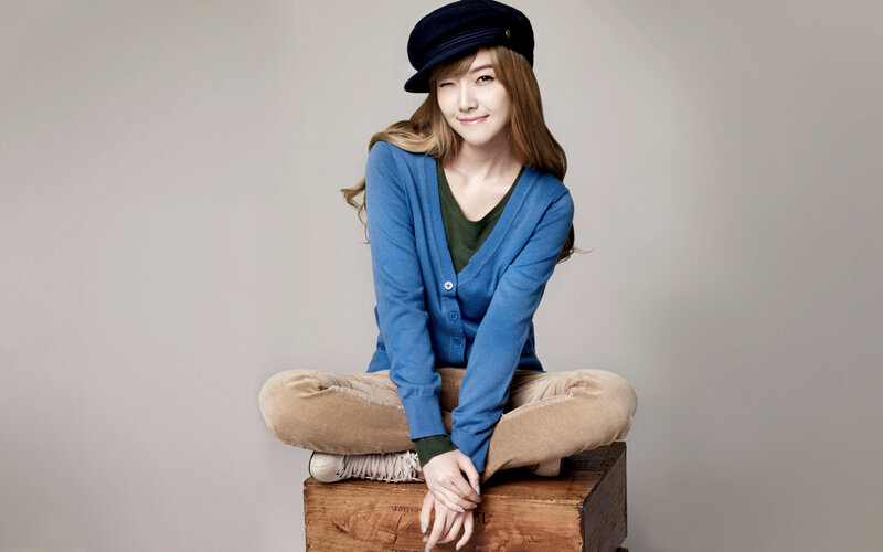 woman in blue cardigan sitting