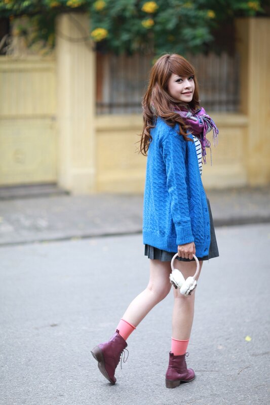 woman in blue cardigan walking