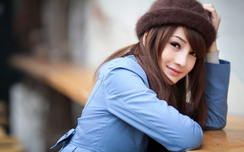 woman in blue coat and hat