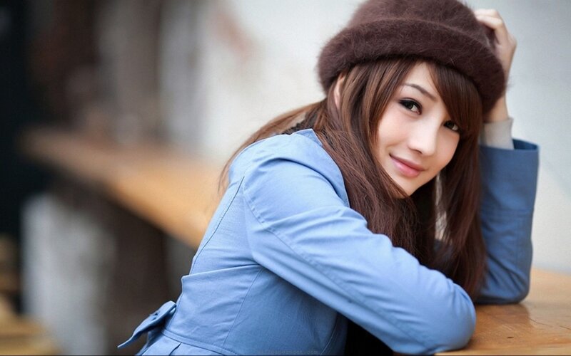 woman in blue coat and hat