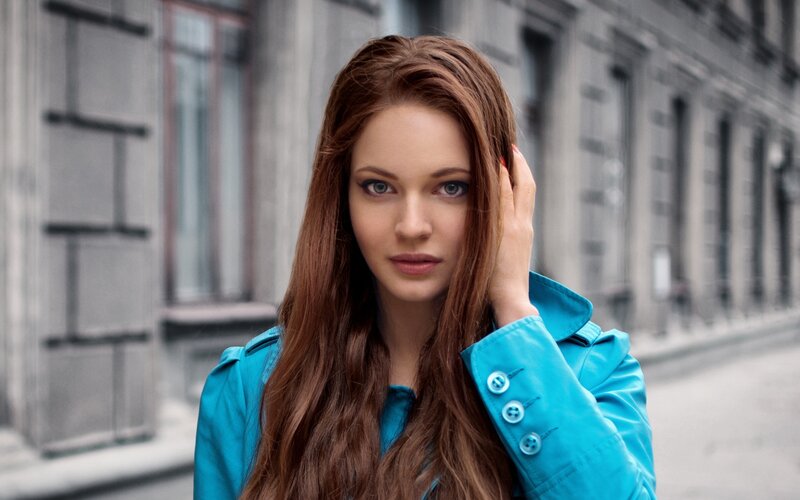 woman in blue coat on street