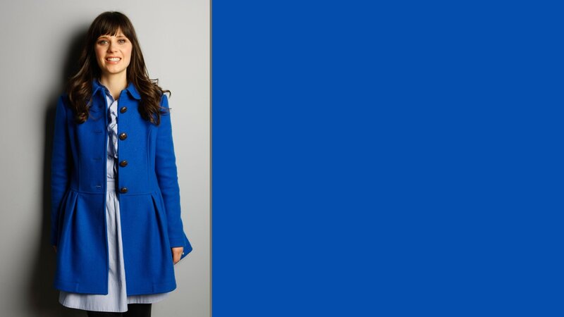 woman in blue coat smiling