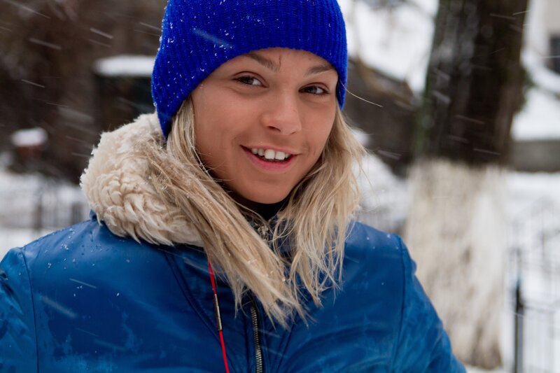 woman in blue coat smiling