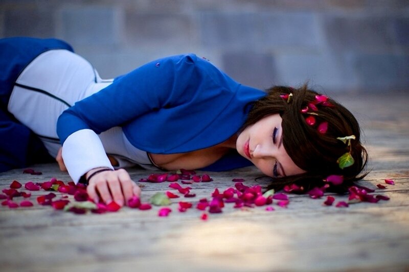 woman in blue costume lying on ground