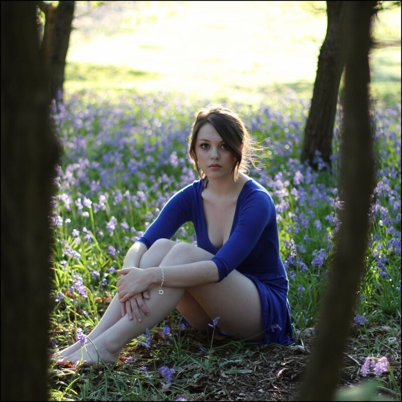 woman in blue dress among flowers