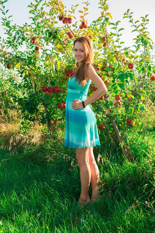 Woman in blue dress at apple orchard