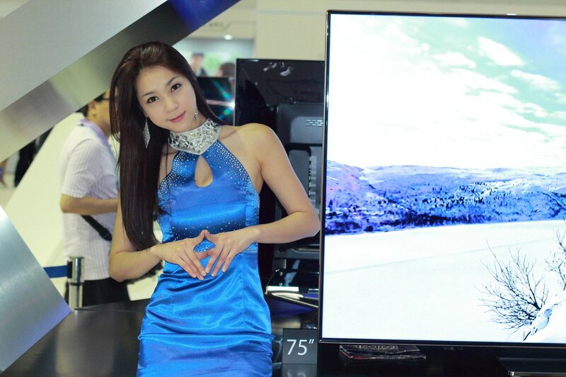 Woman in blue dress at electronics show