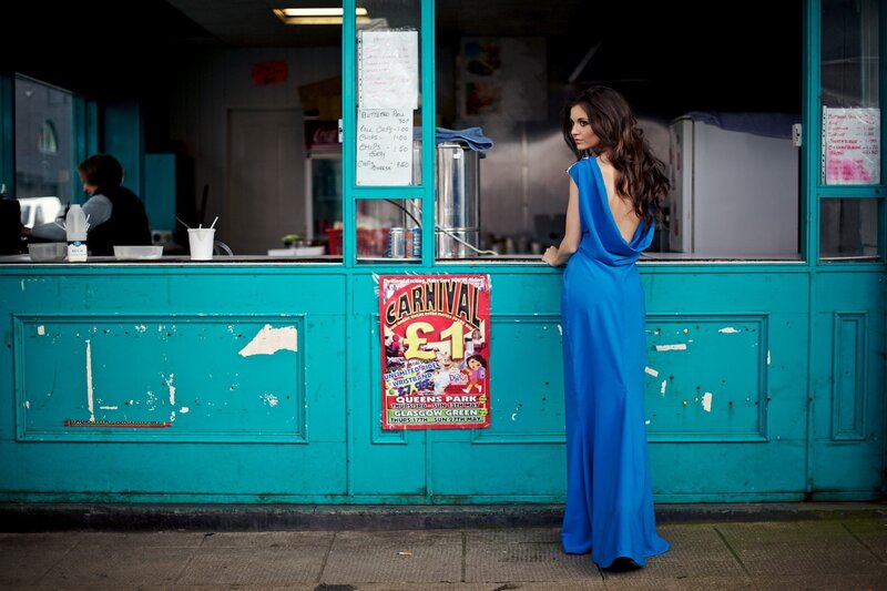 Woman in blue dress at food stall