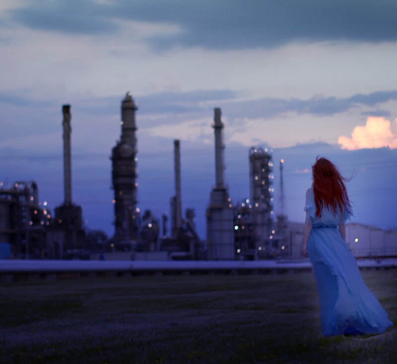 Woman in blue dress at industrial site
