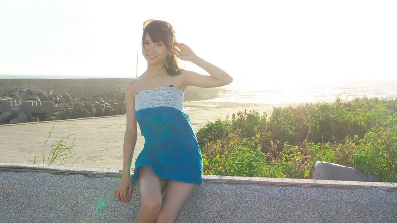 Woman in blue dress at seaside