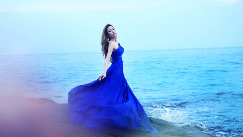 Woman in blue dress at the beach