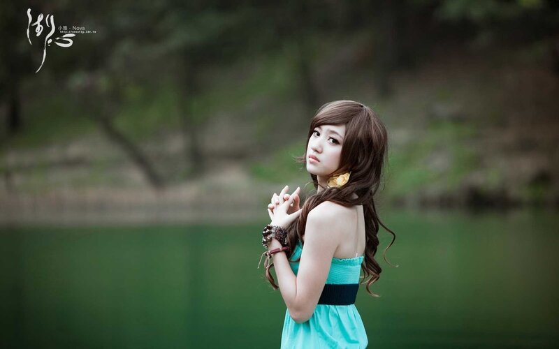 woman in blue dress by lake