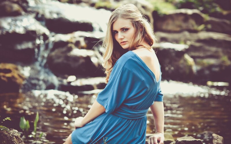 woman in blue dress by stream