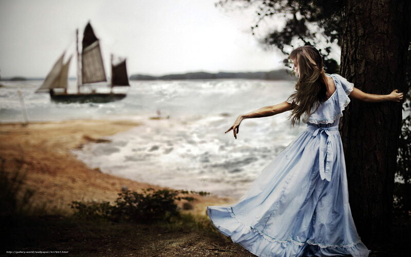 woman in blue dress by the sea