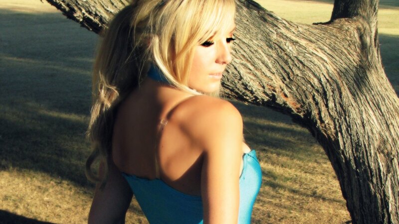 woman in blue dress by tree