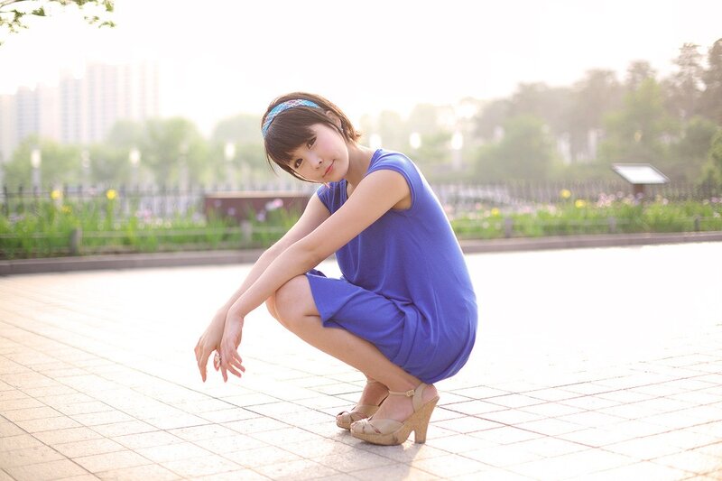 Woman in blue dress crouching