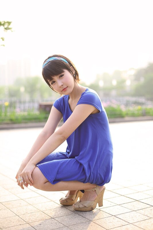 woman in blue dress crouching