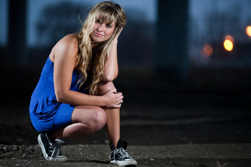 woman in blue dress crouching