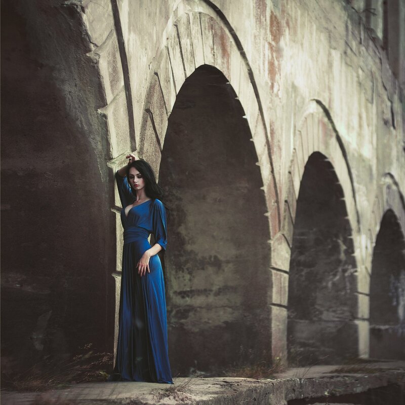 Woman in Blue Dress — Dramatic, Photograph, Arches