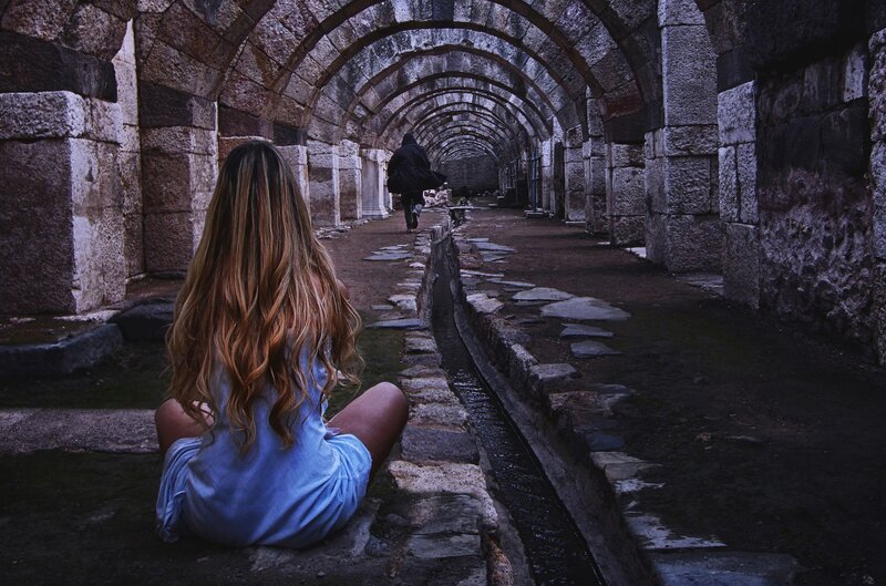 Woman in Blue Dress — Dramatic, Photograph, Stone Arches, Ancient Ruins