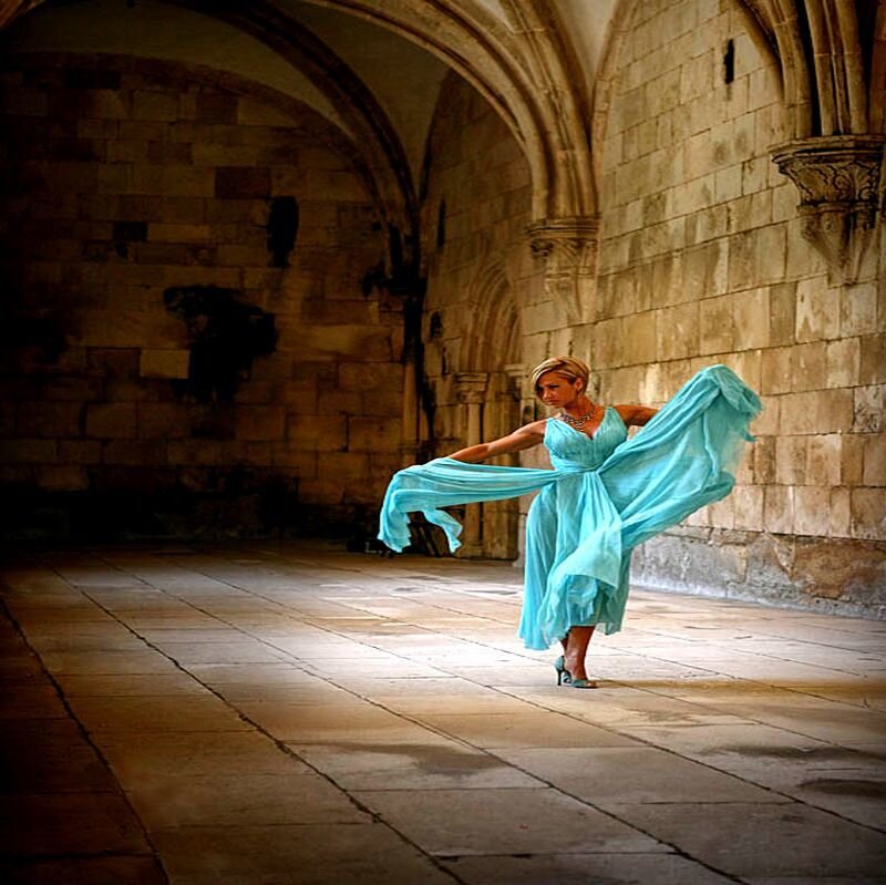 Woman in Blue Dress — Dramatic, Photograph, Stone Arches