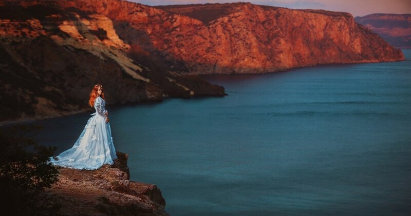 Woman in Blue Dress — Dramatic, Sunset, Photograph, Cliff