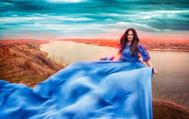 Woman in Blue Dress — Dramatic, Sunset, Photograph, River, Cliff