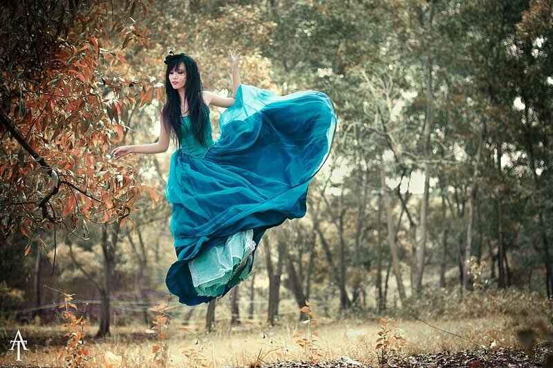 woman in blue dress floating