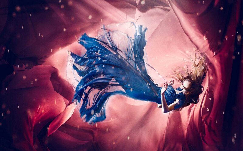 woman in blue dress floating