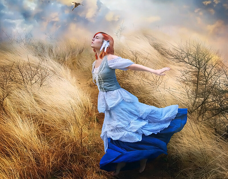 Woman in blue dress in a field