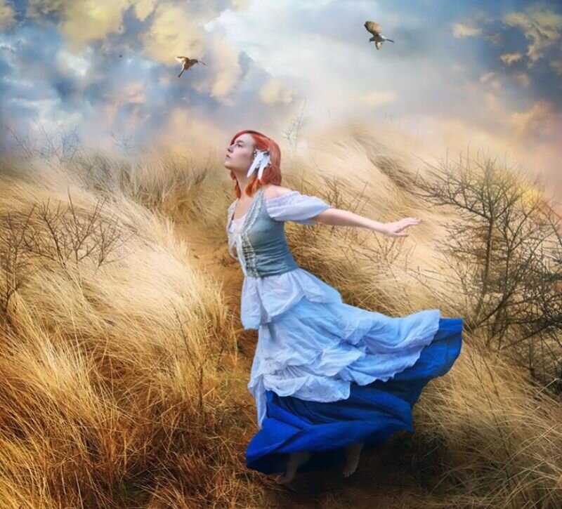 Woman in blue dress in a field