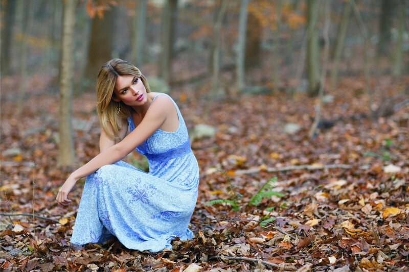 Woman in blue dress in autumn forest