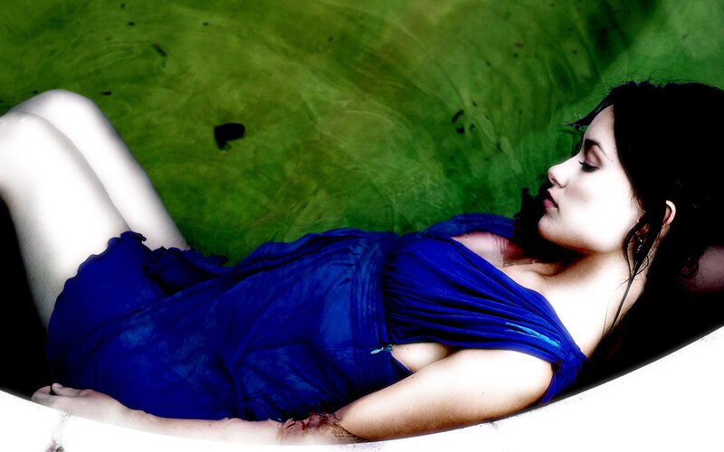 woman in blue dress lying down