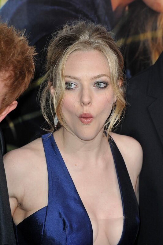 woman in blue dress making a face