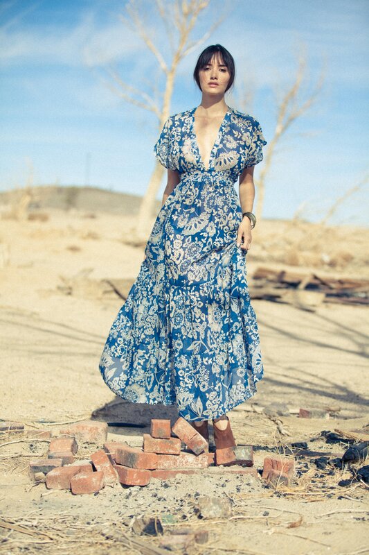 Woman in blue dress on bricks