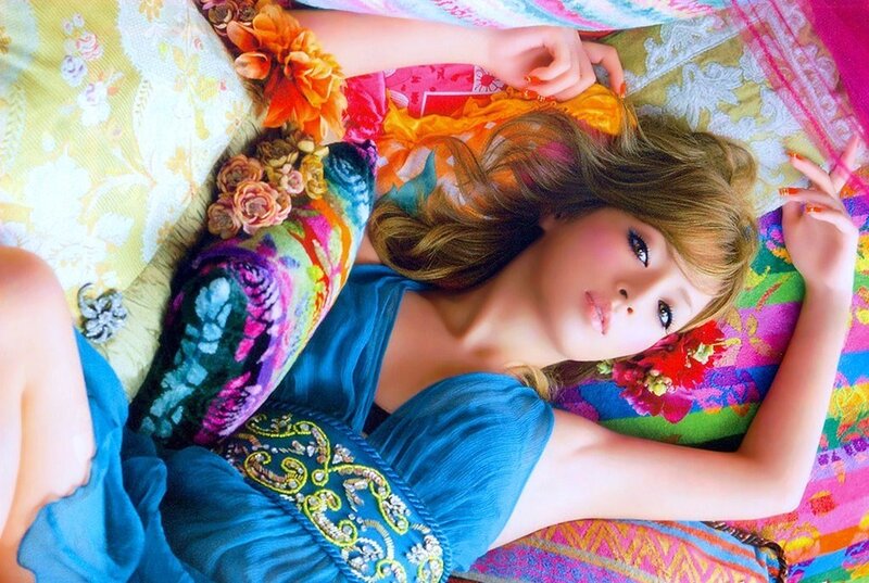 woman in blue dress on colorful bedding