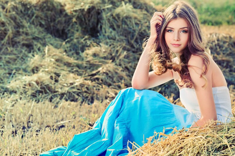 woman in blue dress on hay bale