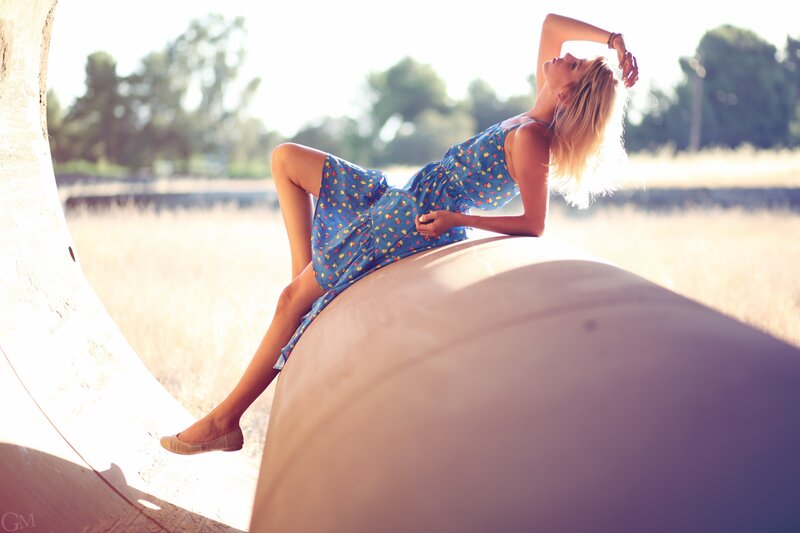 Woman in blue dress on pipe
