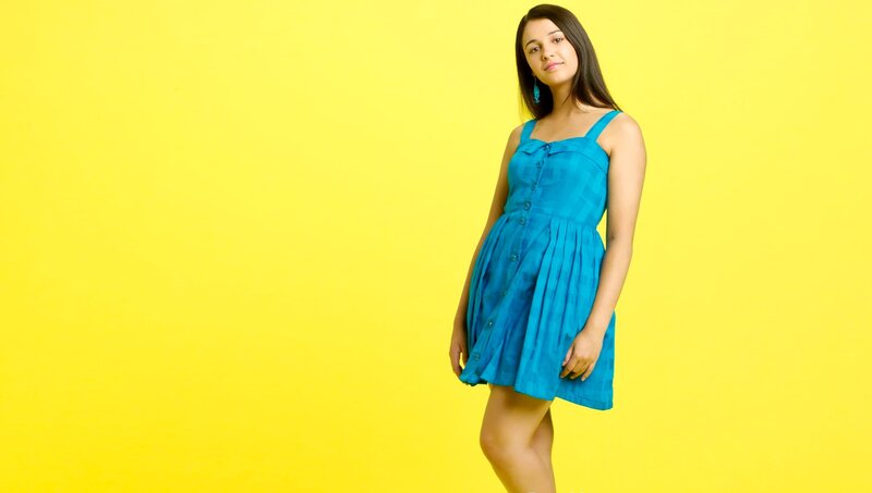 woman in blue dress on yellow