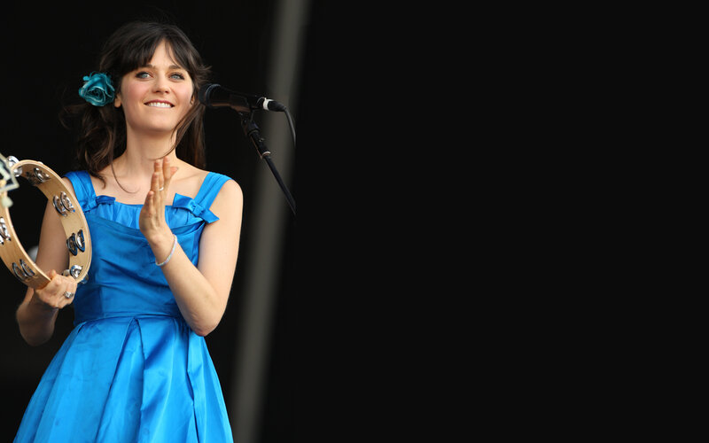 Woman in blue dress playing tambourine