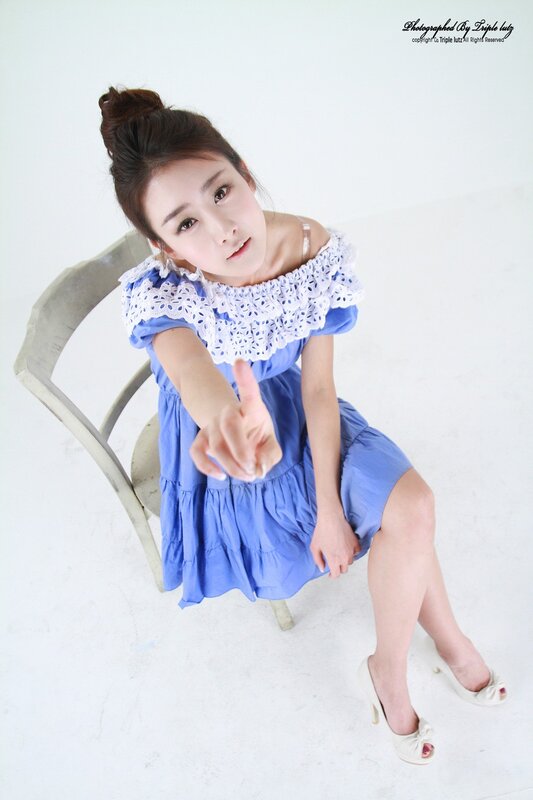 woman in blue dress pointing