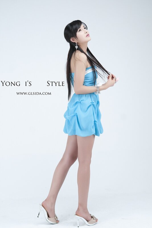 Woman in blue dress posing