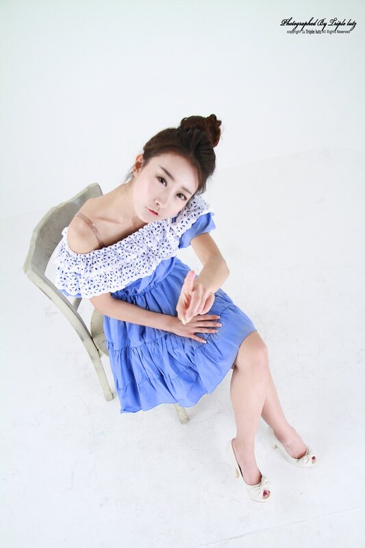 woman in blue dress sitting on chair